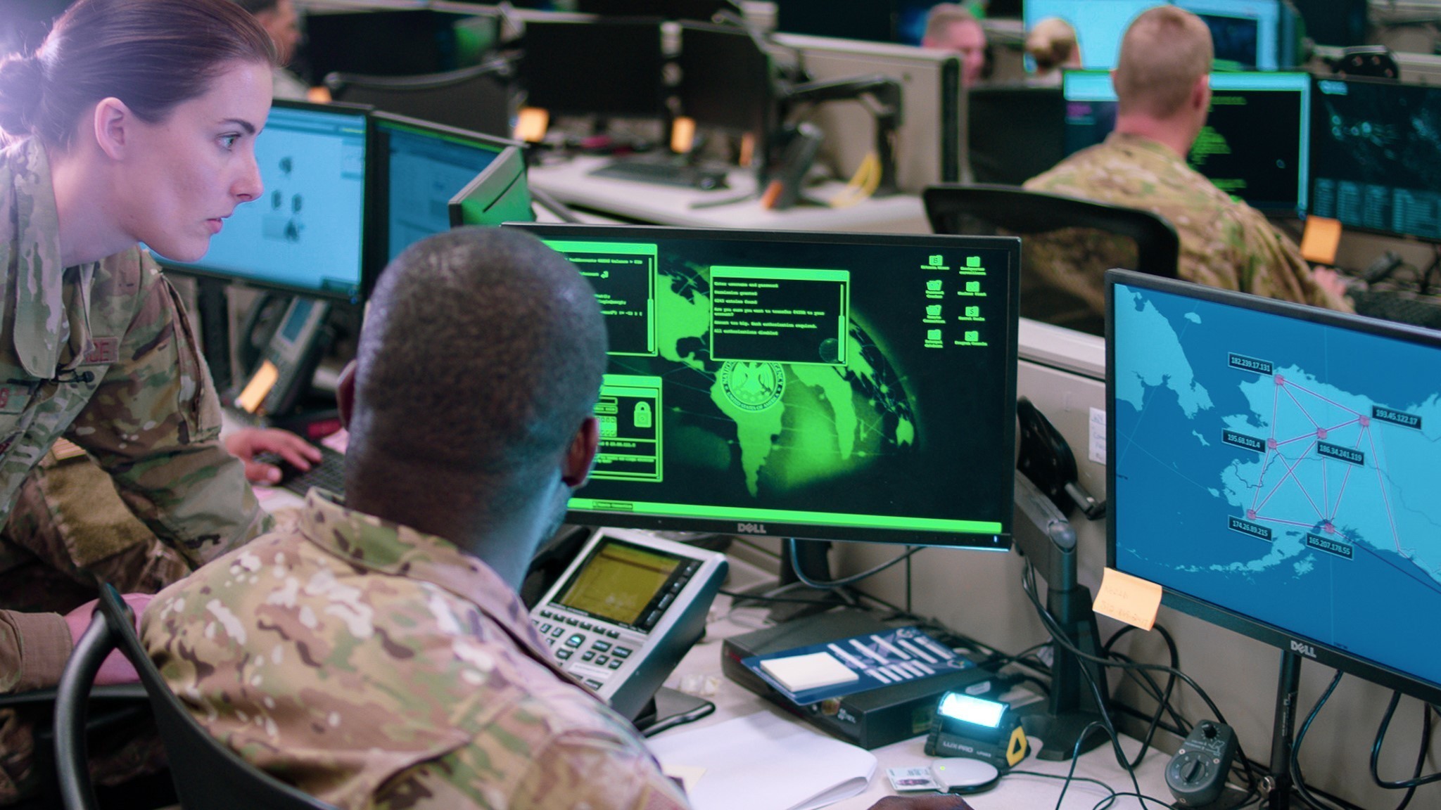 Cybersecurity operations center with analysts reviewing threat-monitoring screens
